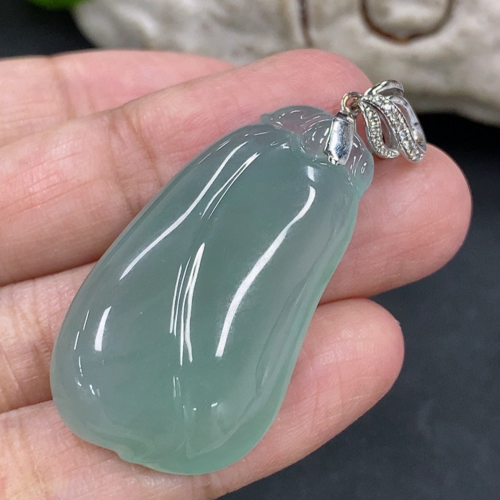 Jadeite pendant featuring blessing melon design with 18K gold accents and diamond details, displayed on a necklace.