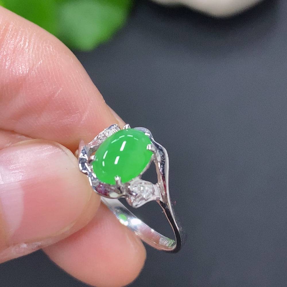 Huiliu jadeite cabochon solitaire ring featuring a smooth, polished green jade stone set in a silver band.