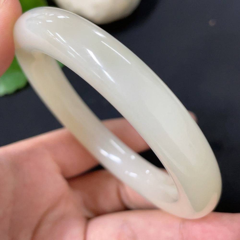 Hetian jade round bangle by HUILIU HQ, size 58.3, smooth polished surface, showcasing natural jade color and craftsmanship.
