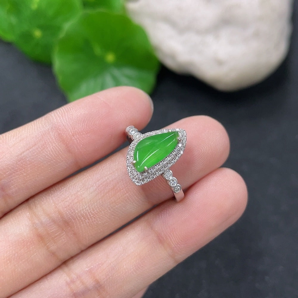 Jadeite ring with 18K gold band and diamond accents, size 13, weighing 2.34g, featuring intricate craftsmanship.