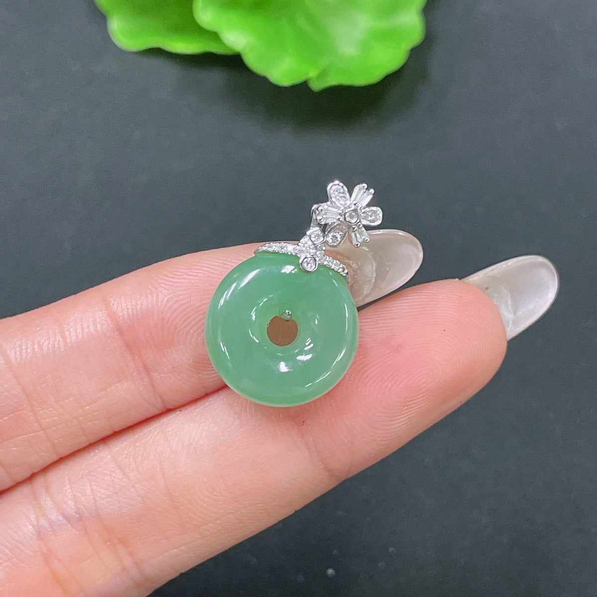 Jadeite pendant with peace knot design, 18k gold inlay, diamond accents, from HUILIU HQ, showcasing intricate craftsmanship.