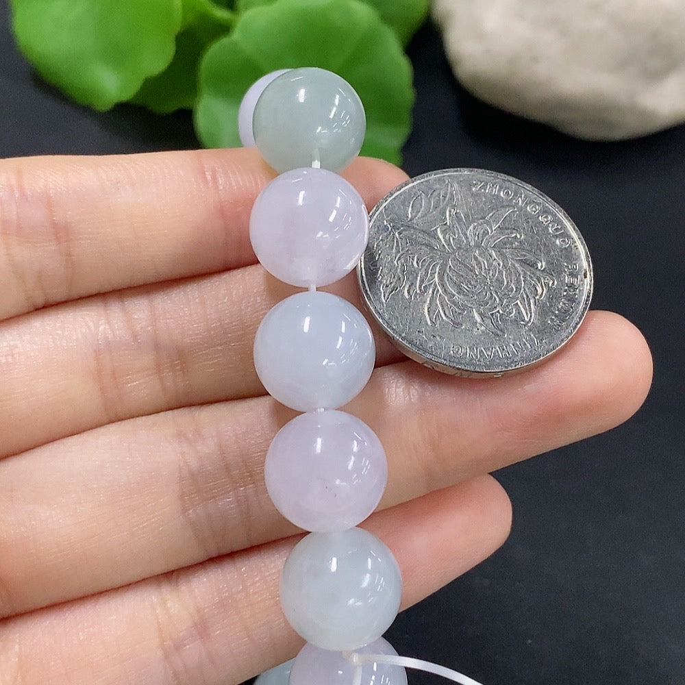 HKHQ jadeite bracelet weighing 48.59g, showcasing smooth, polished green jadeite beads on a stylish bracelet.