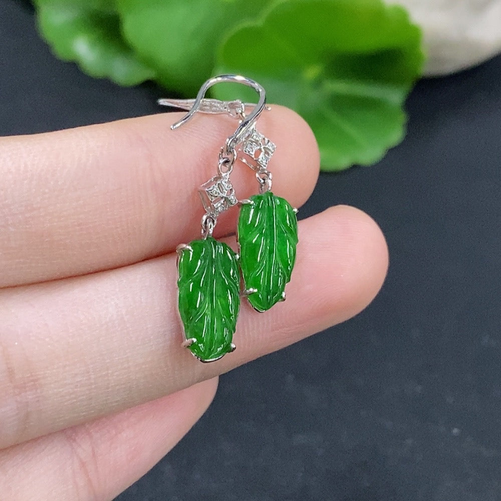 Jadeite leaf inlaid earrings with 18k gold and diamond accents, featuring delicate leaf design and polished finish.