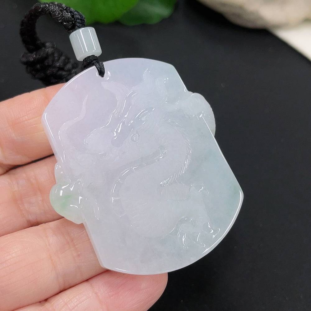 Jadeite dragon pendant with intricate design, weighing approximately 34.52g, featuring a green jade jadeite stone and a rope attachment.