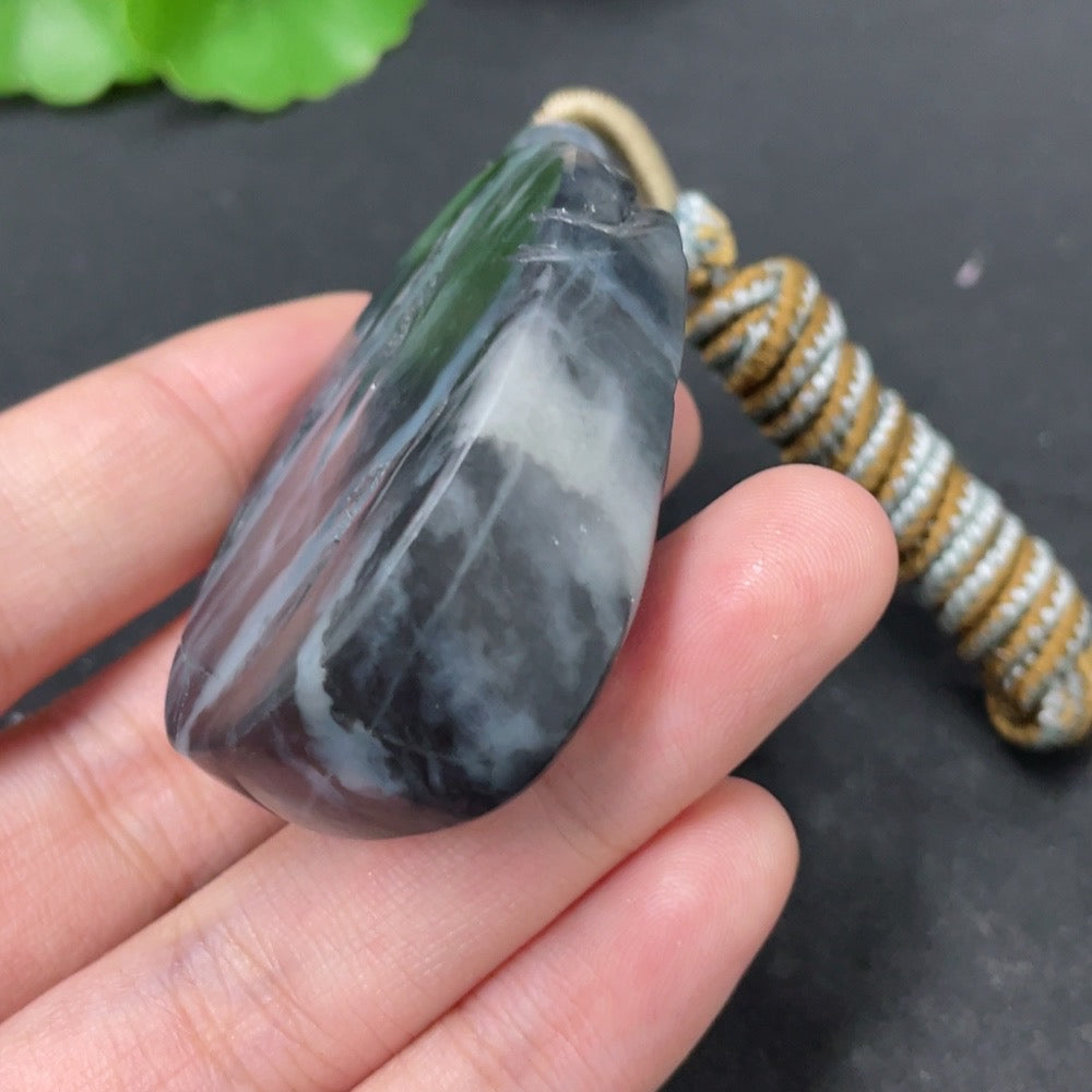 HKHQ Hetian Jade pendant featuring a landscape design, weighing approximately 54g including the rope, showcasing smooth jade surface.