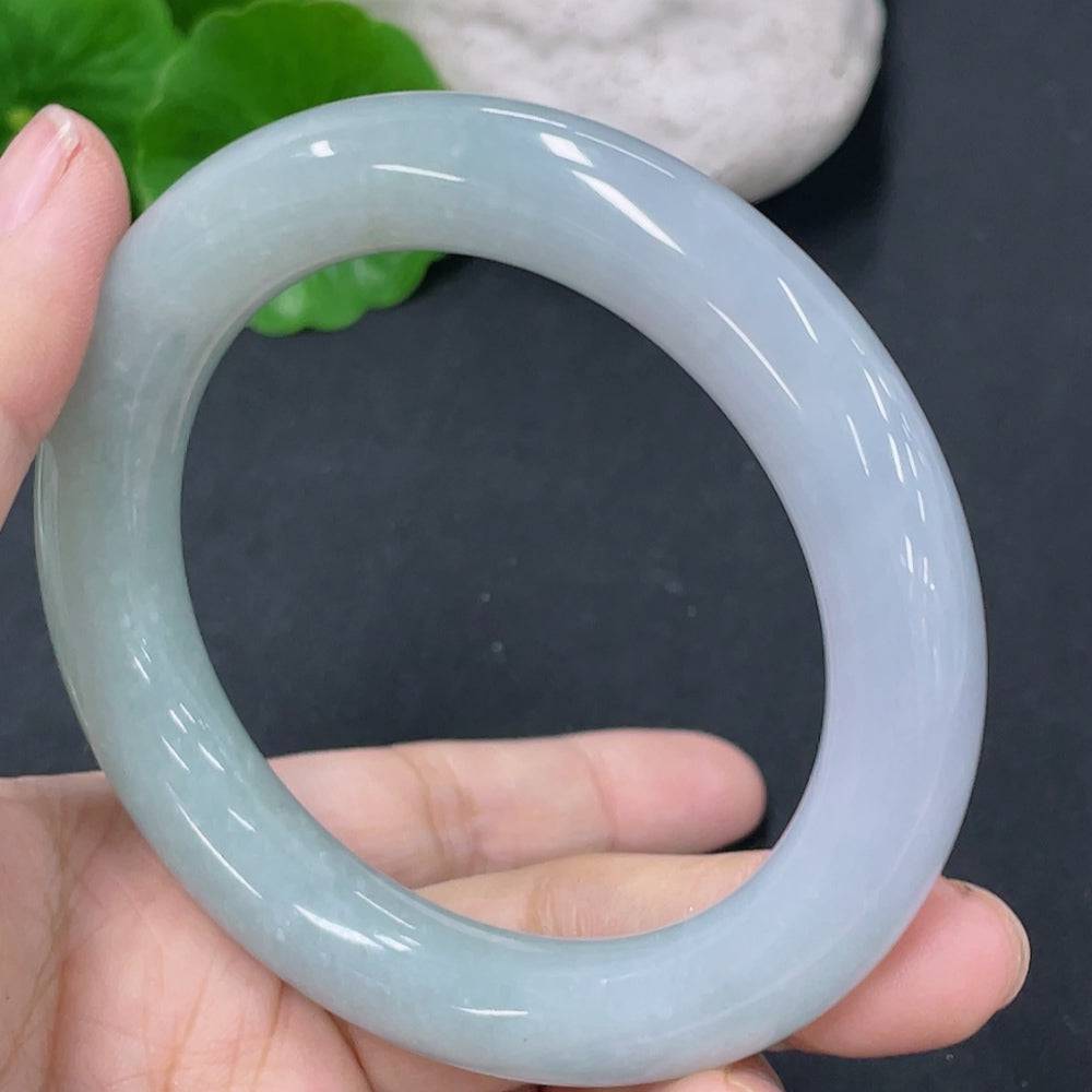 Huiliu Certified Jadeite round bangle with crack, showcasing smooth jade surface and natural green coloration.