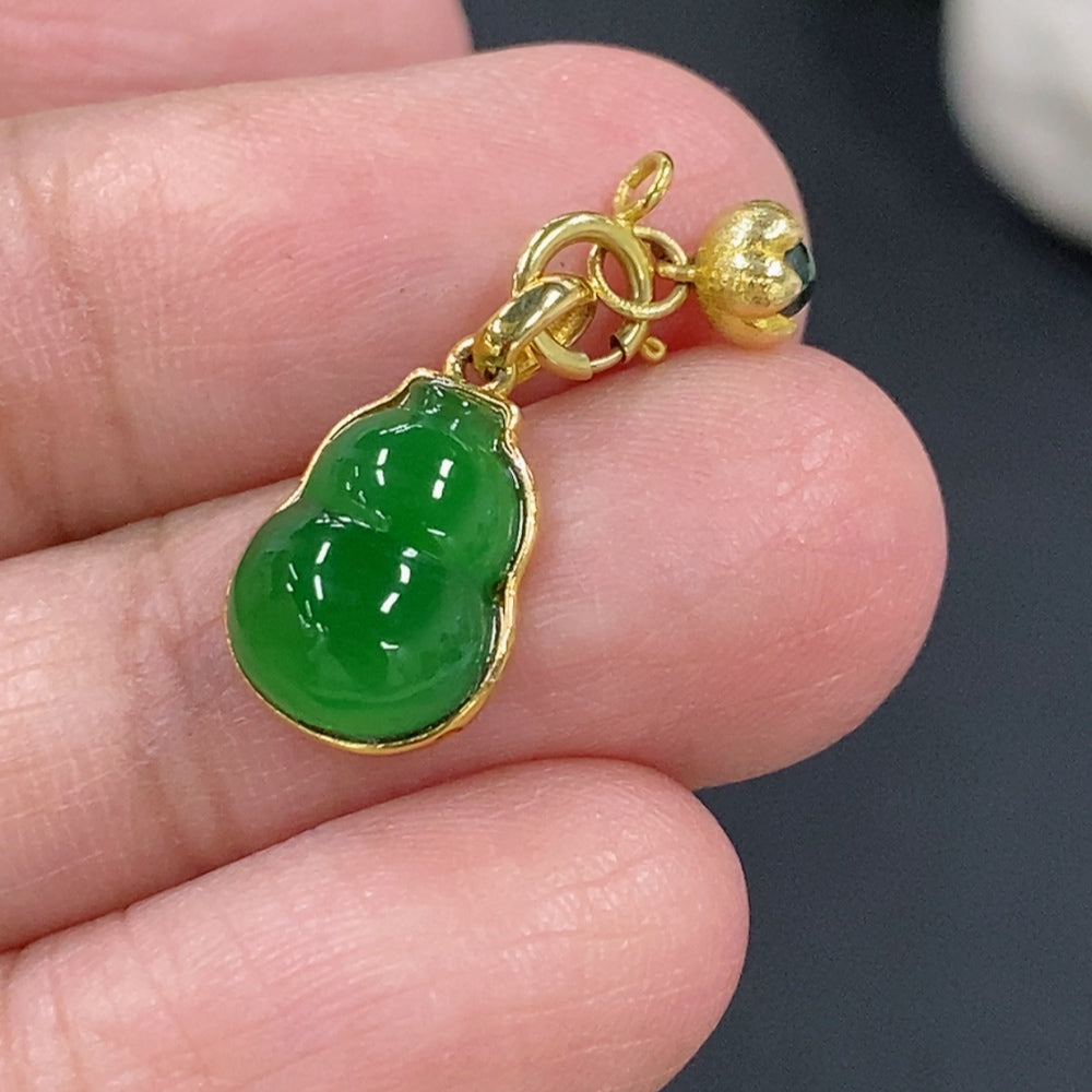 Jadeite gourd pendant with 18K gold on a necklace, featuring smooth green jade and a polished gold bail.