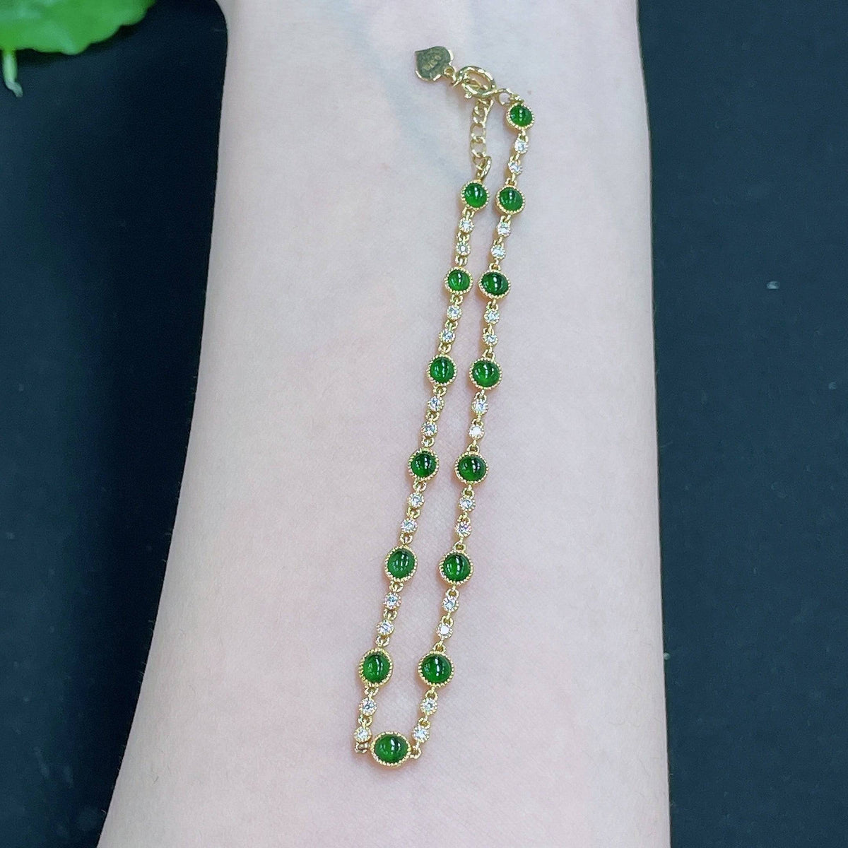 Jadeite cabochon inlaid bracelet by HUILIU HQ featuring 18k gold and diamond accents, weight approximately 4.09 grams.