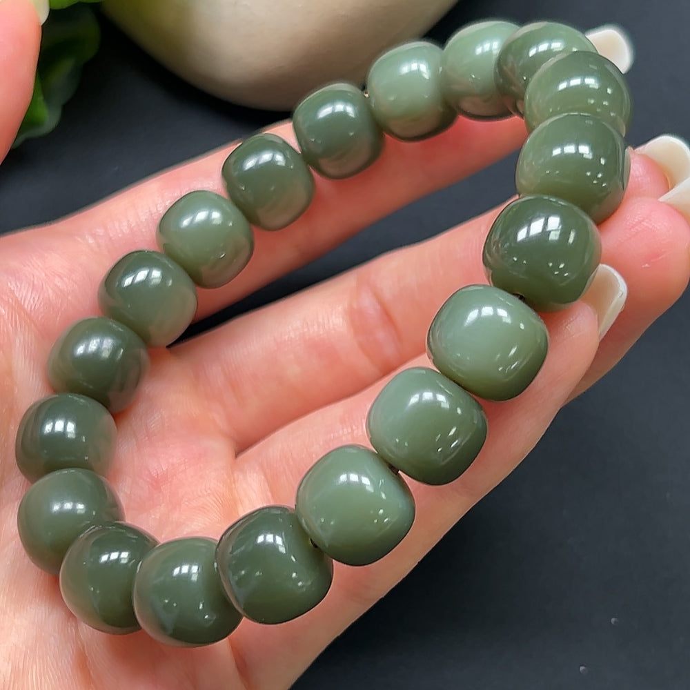 Elegant Hetian Jade bracelet with 12mm beads, showcasing smooth, polished jade stones on a delicate bracelet.