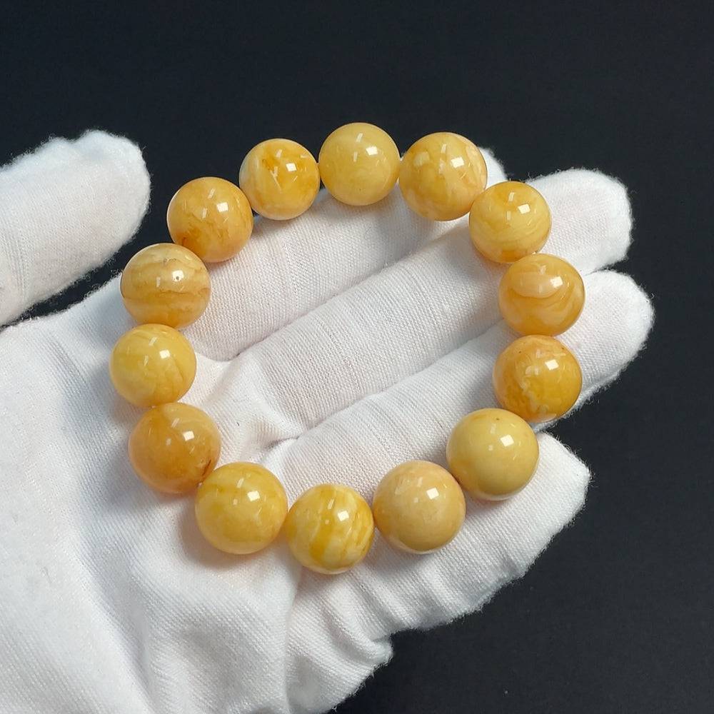 Amber beeswax bracelet from HUILIU HQ featuring 13.8mm amber beads, weighs approximately 19.24g, natural warm amber color.
