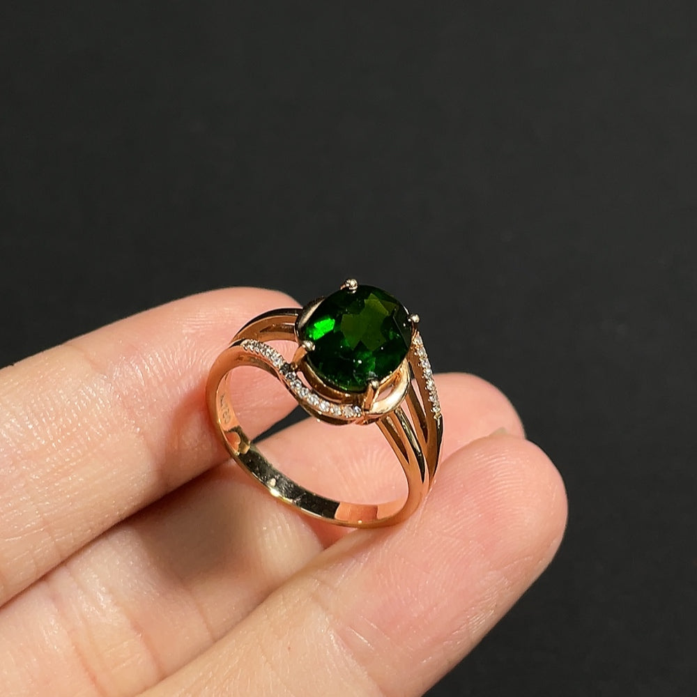 Diopside ring with diamond accents in 18K gold, featuring a polished band and sparkling gemstone details.