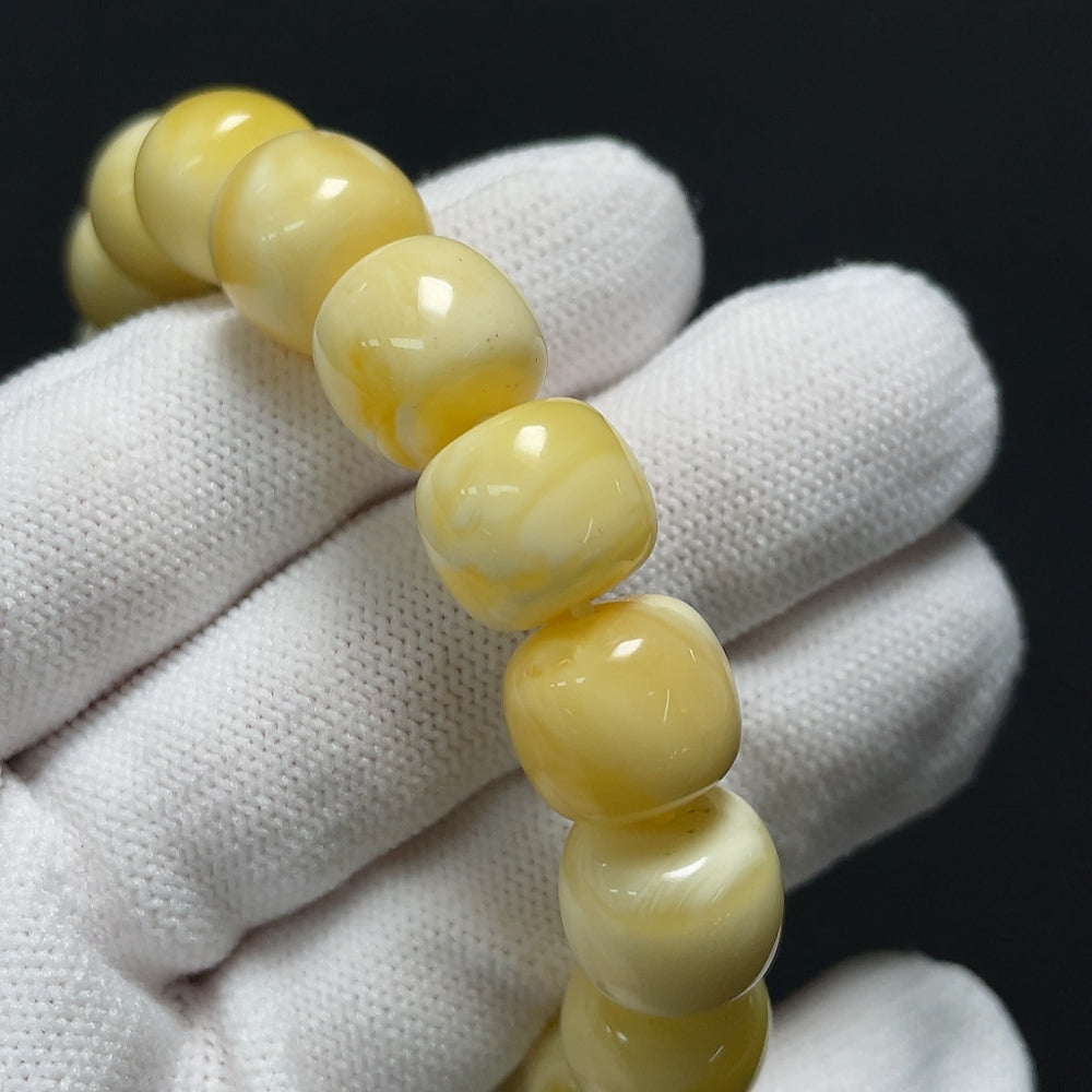 Amber Beeswax bracelet by HKHQ featuring natural amber beads on a durable cord, showcasing warm, golden tones and handcrafted detail.
