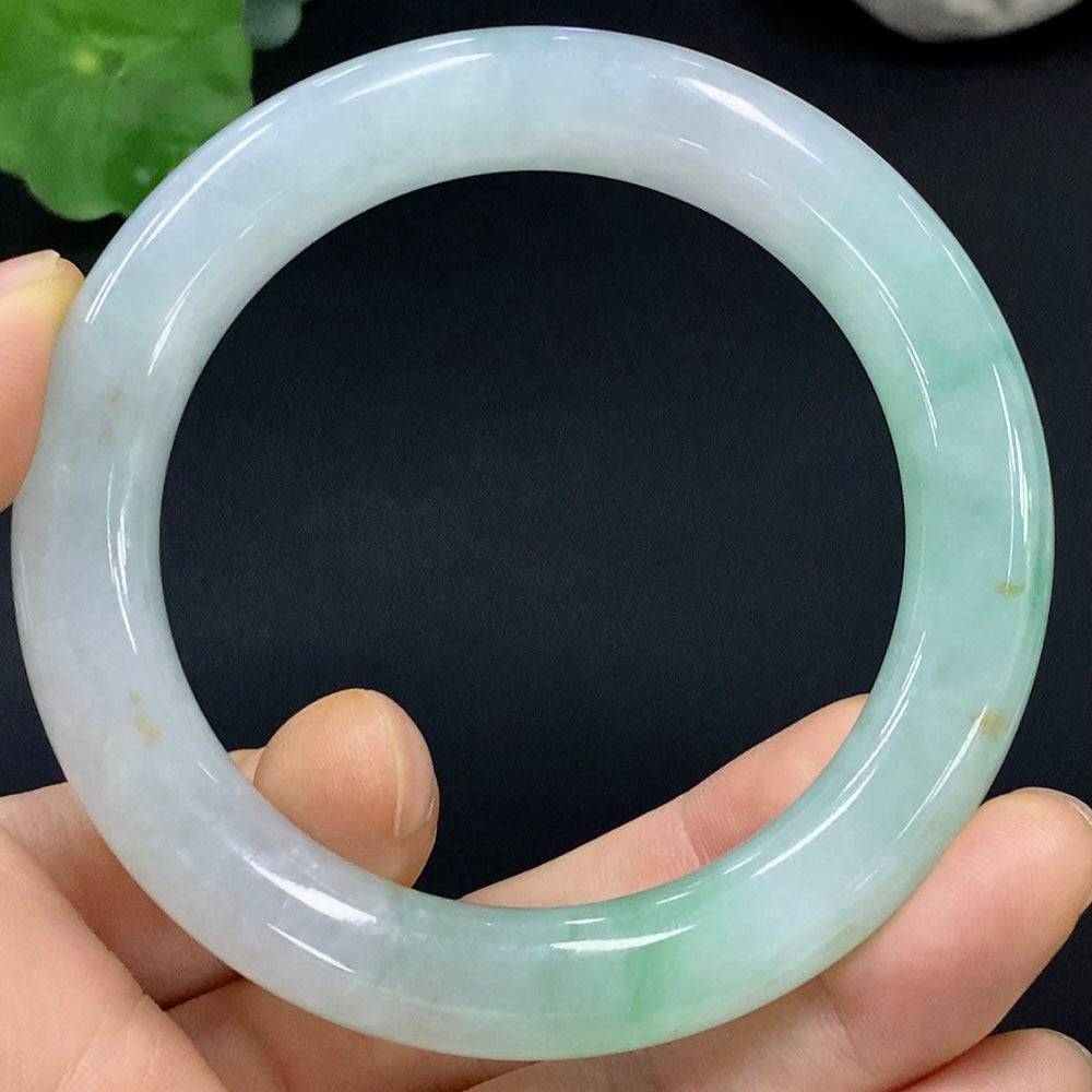 Huiliu certified jadeite round bangle featuring smooth, polished green jade surface and traditional circular design.