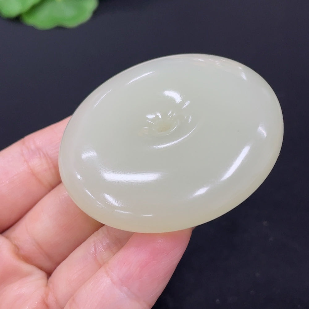 Hetian jade pendant with peace knot design, crafted from HKHQ jade, weighing approximately 58.6 grams, showcasing intricate carving.