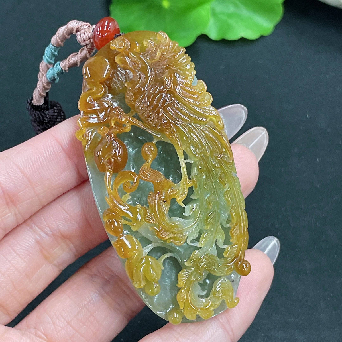 Jadeite phoenix pendant on cord, weighing approximately 45.37g, crafted by HUILIU HQ with intricate jade design.