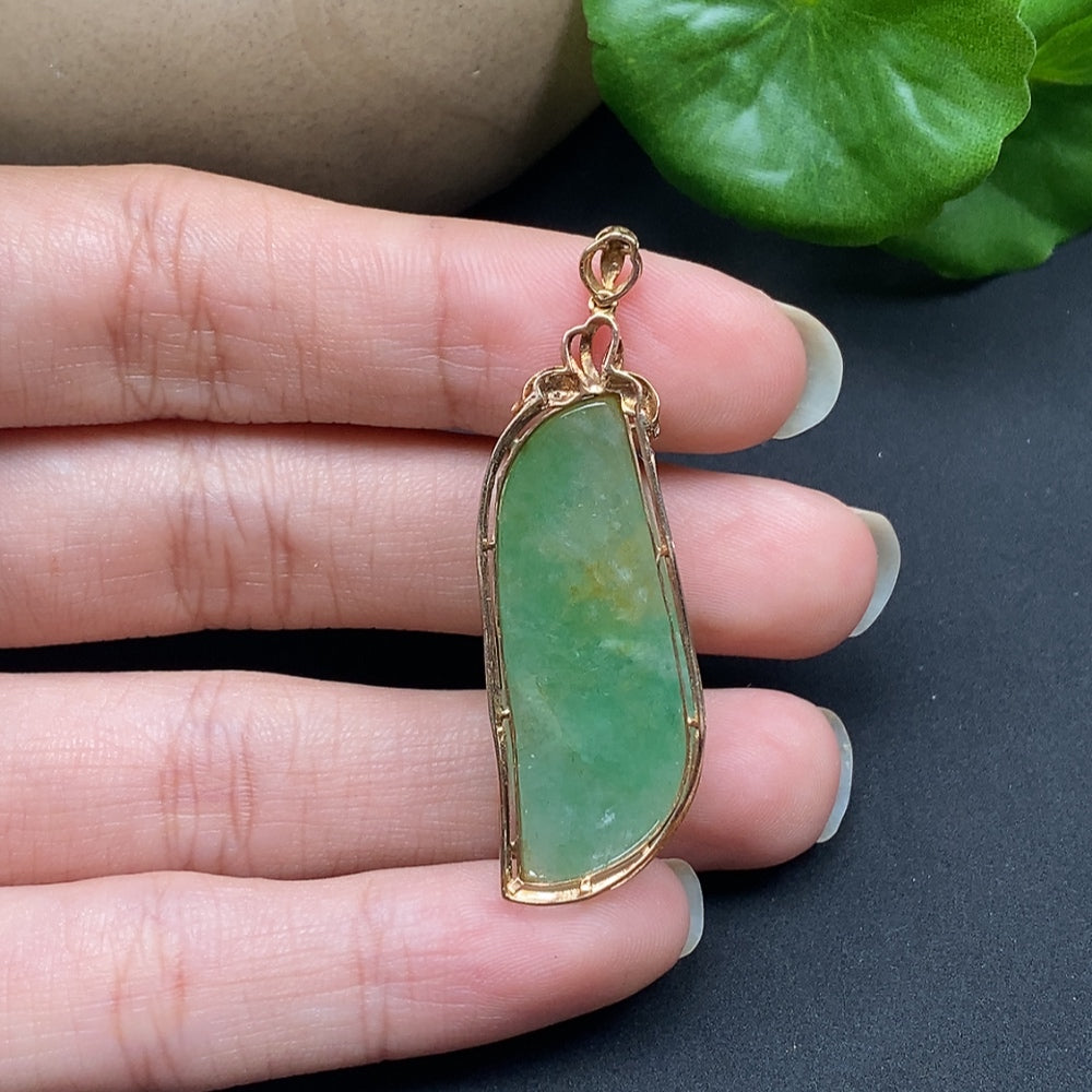 Jadeite inlaid pendant with diamond accents on an 18K gold necklace, featuring intricate craftsmanship and elegant design.