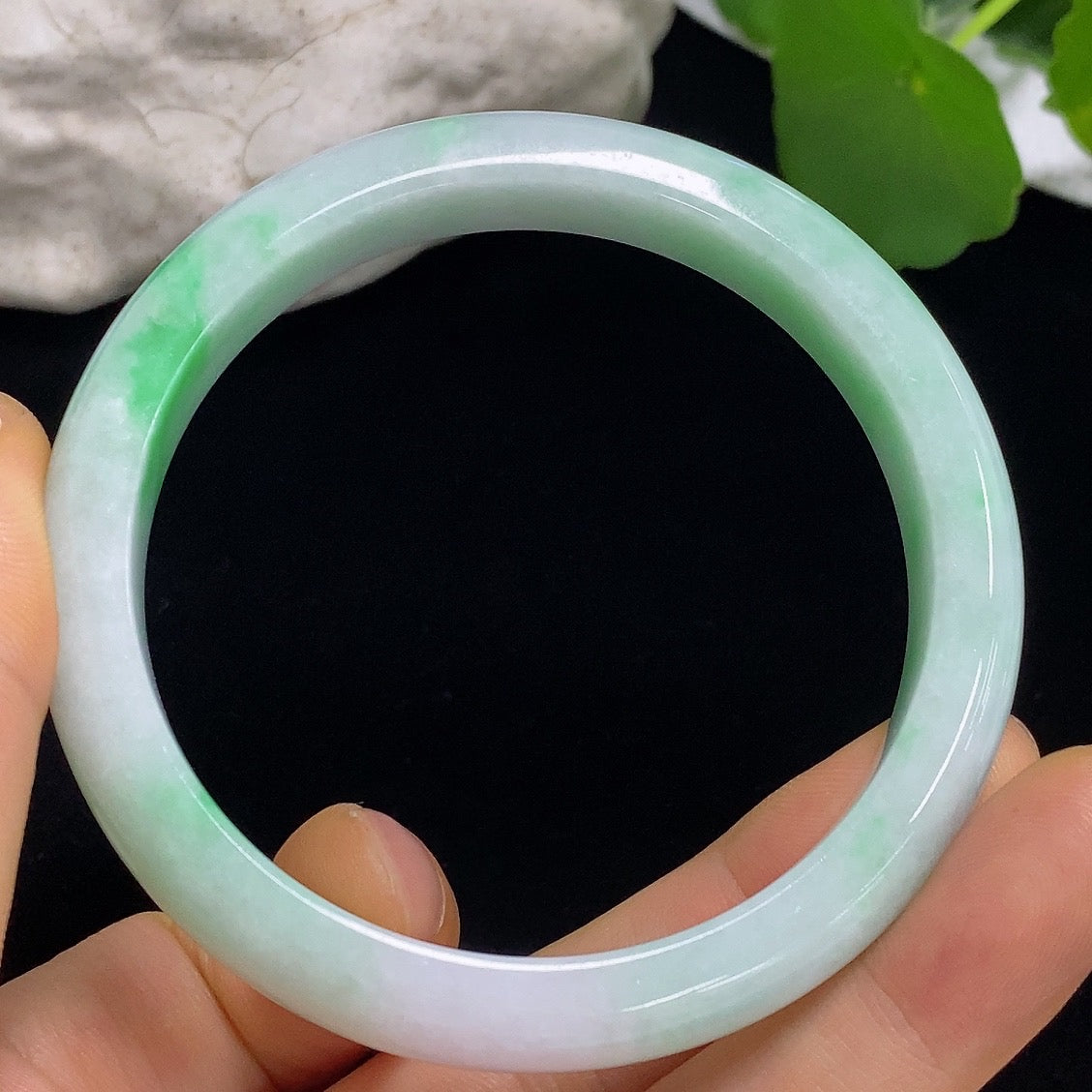 Jadeite round bangle with size 57.3 and weight 43.82g, crafted from green jade, by HKHQ, displayed on a neutral background.