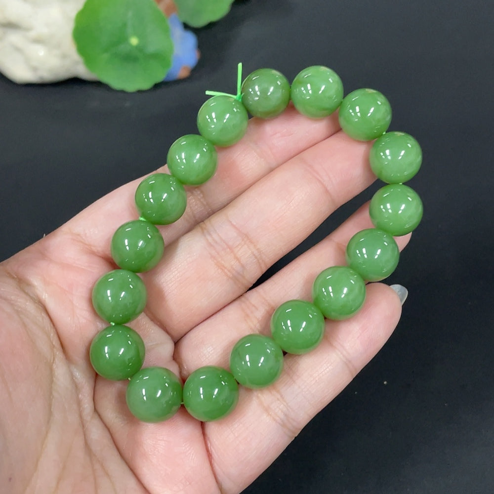 Huiliu certified Hetian Jade bracelet with 11.8mm round jade beads, showcasing smooth, polished green jade stones.