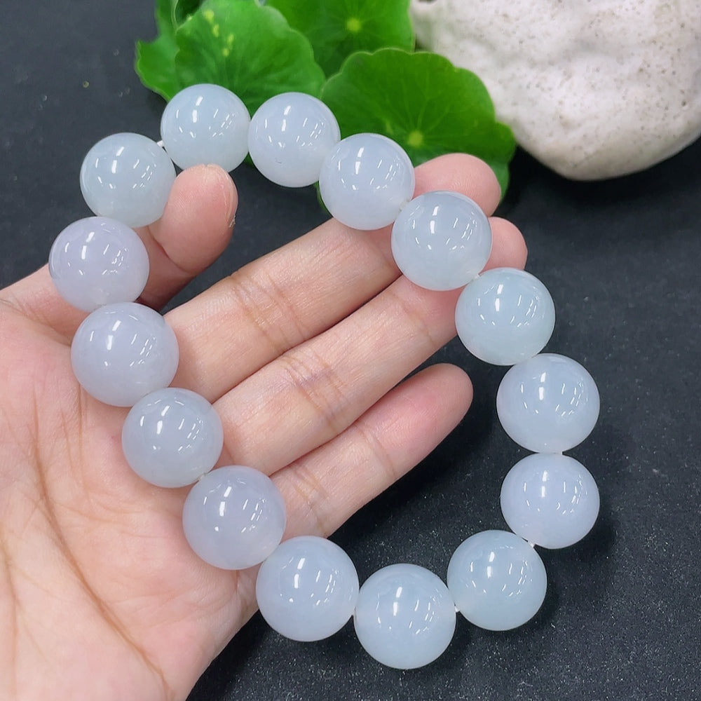 HKHQ jadeite bracelet featuring 15.4mm smooth, polished jadeite beads displayed in a close-up shot