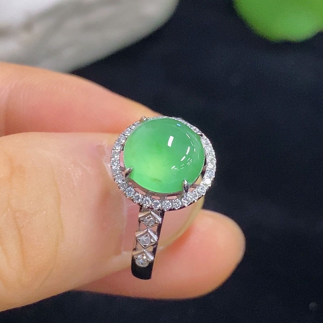 HKHQ jadeite cabochon ring with inlaid design, 18K gold band and diamond accents, close-up view of the elegant jewelry piece