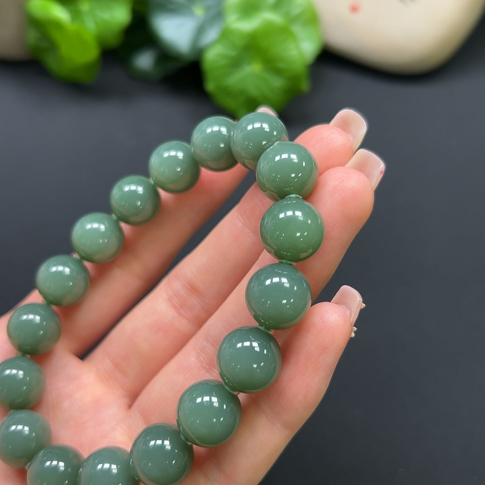 HKHQ Hetian Jade bracelet weighing 45g, featuring smooth, polished green jade stones and a traditional bracelet design.