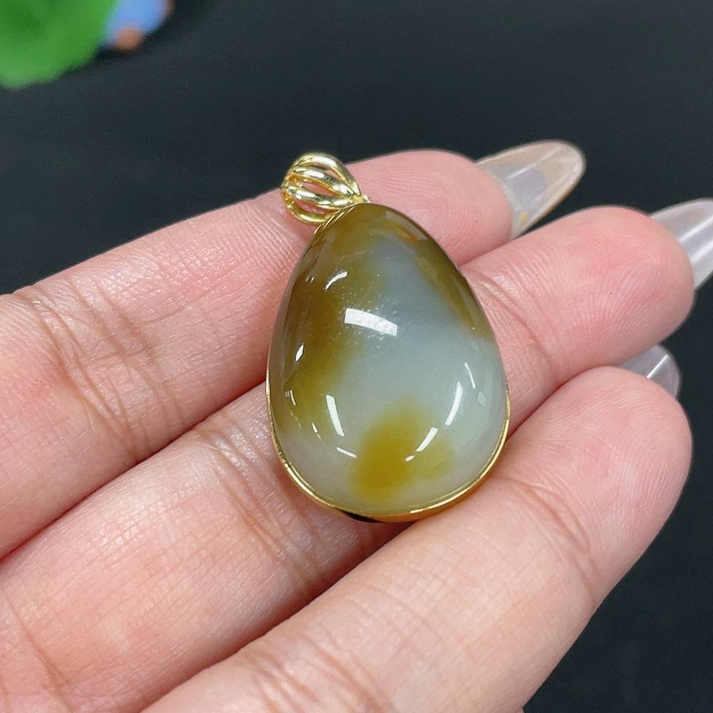 Huiliu certified Hetian Jade water drop pendant with intricate inlaid design, showcasing smooth, polished jade craftsmanship.