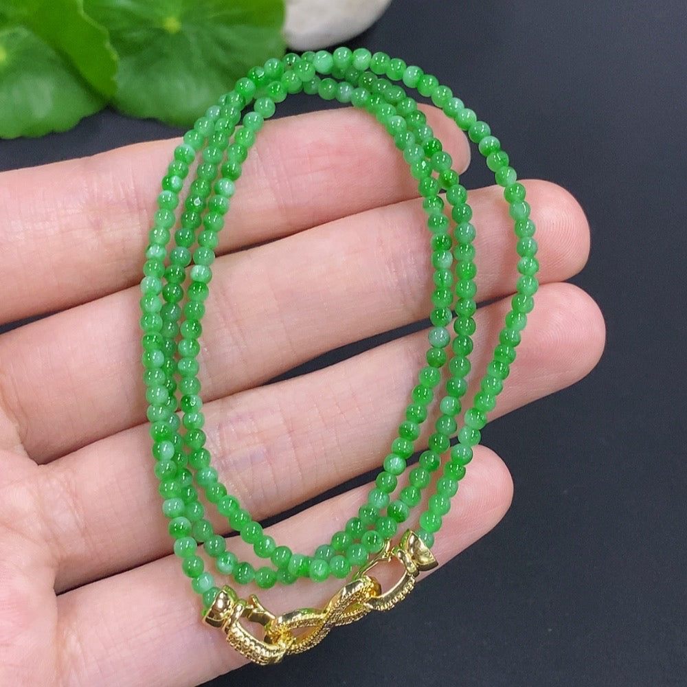 Jadeite bead necklace by HKHQ featuring smooth, green jade beads, non-gold, weight 7.7 grams, styled for elegant wear