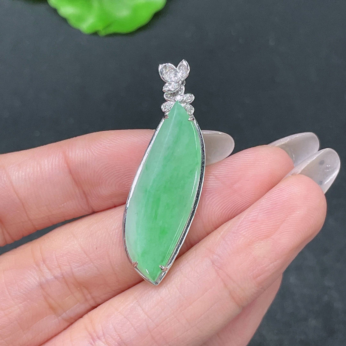 Huiliu Jadeite pendant with Fu Gua symbol and diamonds, showcasing intricate jade craftsmanship and sparkling gemstone accents.