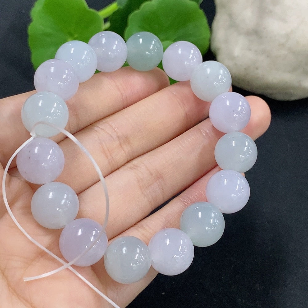 HKHQ jadeite bracelet weighing 48.59g, featuring smooth green jade stones with a polished finish, displayed on a neutral background.