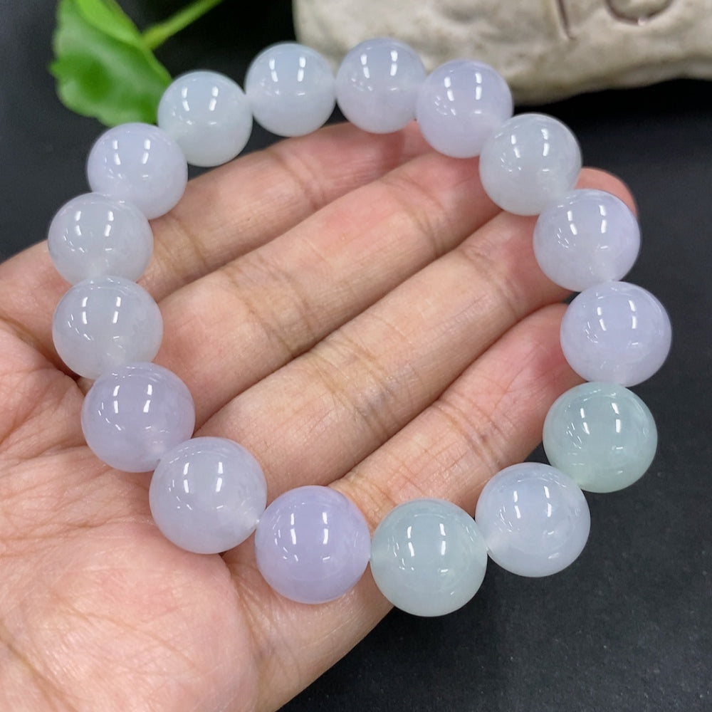 HKHQ jadeite bracelet with 12mm beads, showcasing smooth, polished green jadeite stones on a white background.