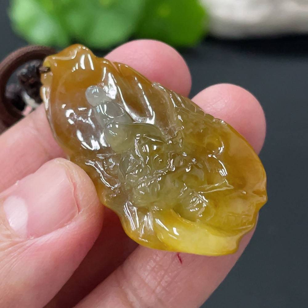 Huiliu Jadeite Enlightenment Pendant featuring smooth, green jade with carved intricate design, hanging from a delicate cord.