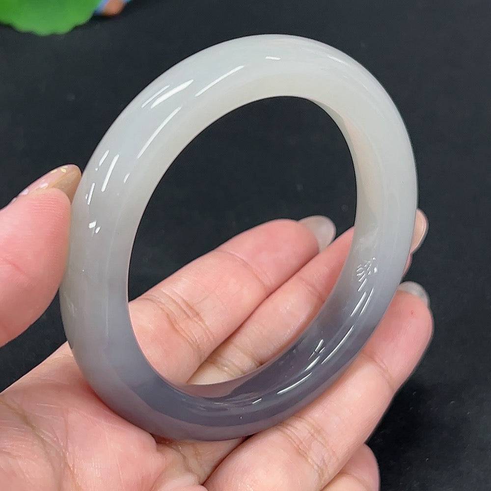 Huiliu Certified Hetian Jade round bracelet showcasing smooth, polished green jade beads on a delicate string.