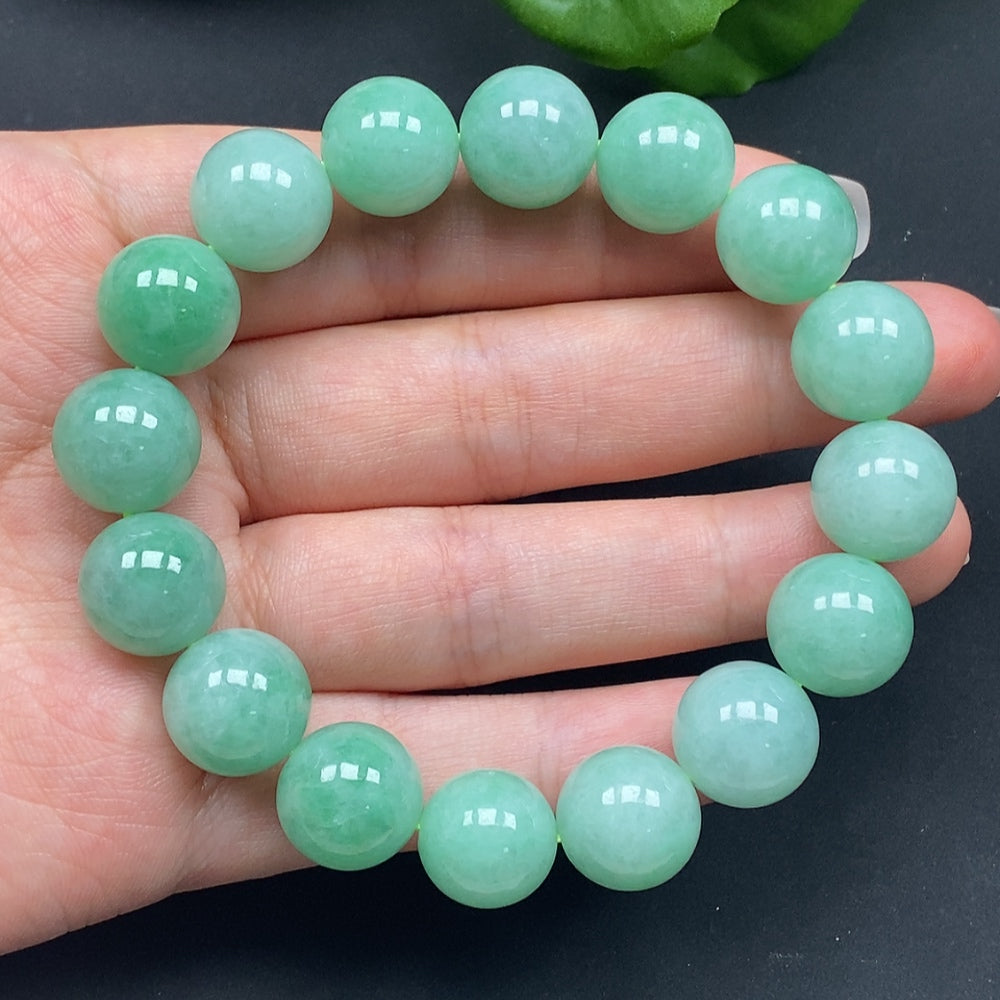 HKHQ jadeite bracelet with natural green stones, approximately 12.8 inches long and 57.85g in weight, showcasing smooth, polished beads.