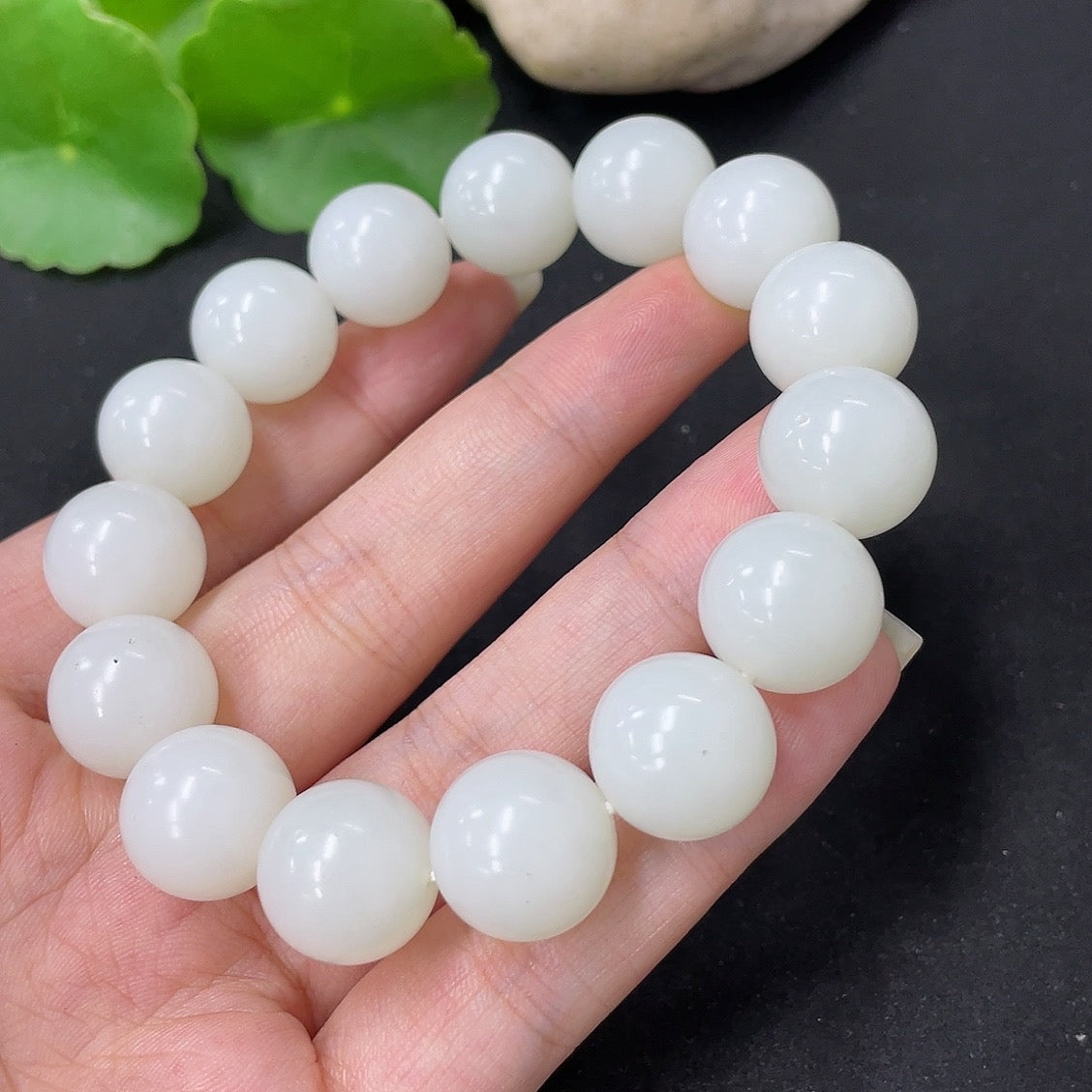 Hetian Jade bracelet with 13.6mm beads, approximately 62g, featuring smooth, polished green jade stones on a bracelet.
