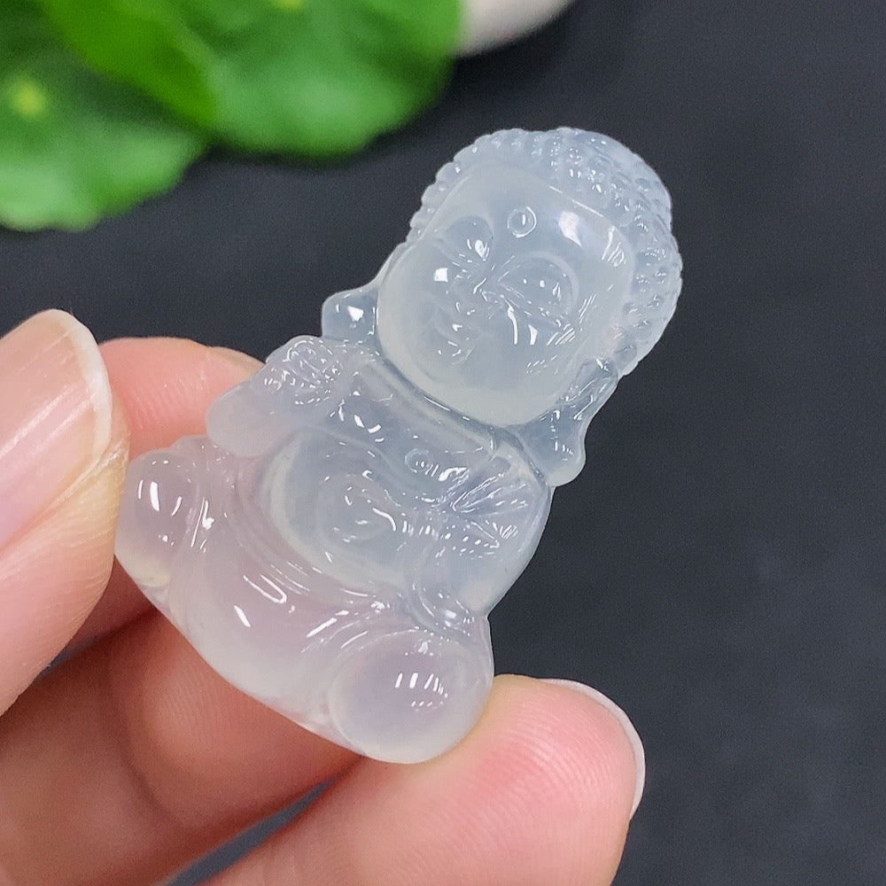 Jadeite Baby Buddha pendant from HUILIU HQ, weighing approximately 7.5g, featuring a smooth, polished jade surface and intricate Buddha design.