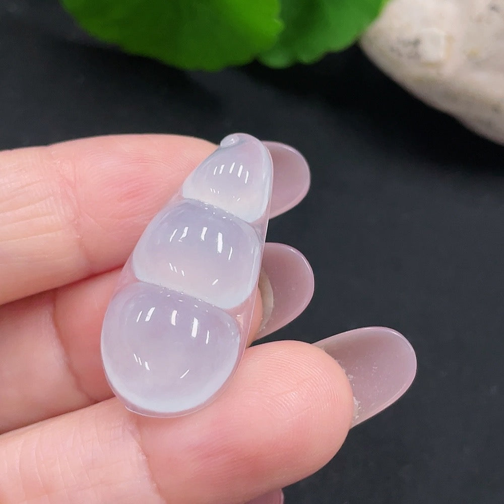 Huiliu Jadeite Lucky Bean Pendant showcasing smooth green jade with carved details, hanging on a silver chain.