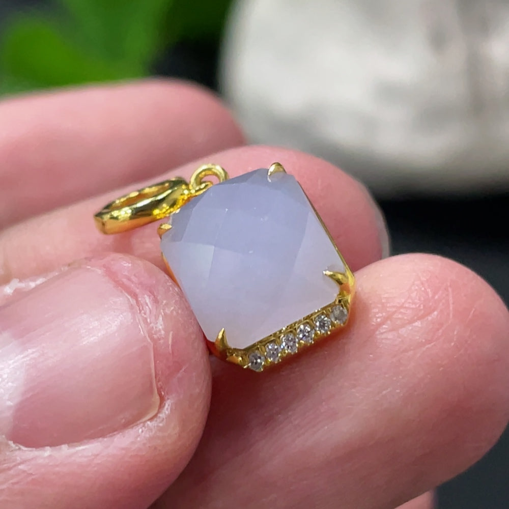 Huiliu jadeite pendant with diamond accents and mount, featuring a polished green jade stone on a delicate jewelry setting.