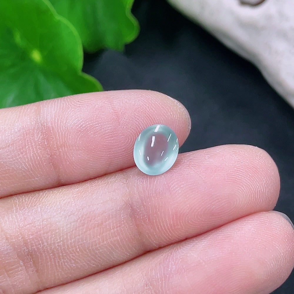HKHQ jadeite cabochon jewelry piece, 0.27g, smooth polished gemstone with vibrant green color and glossy finish.