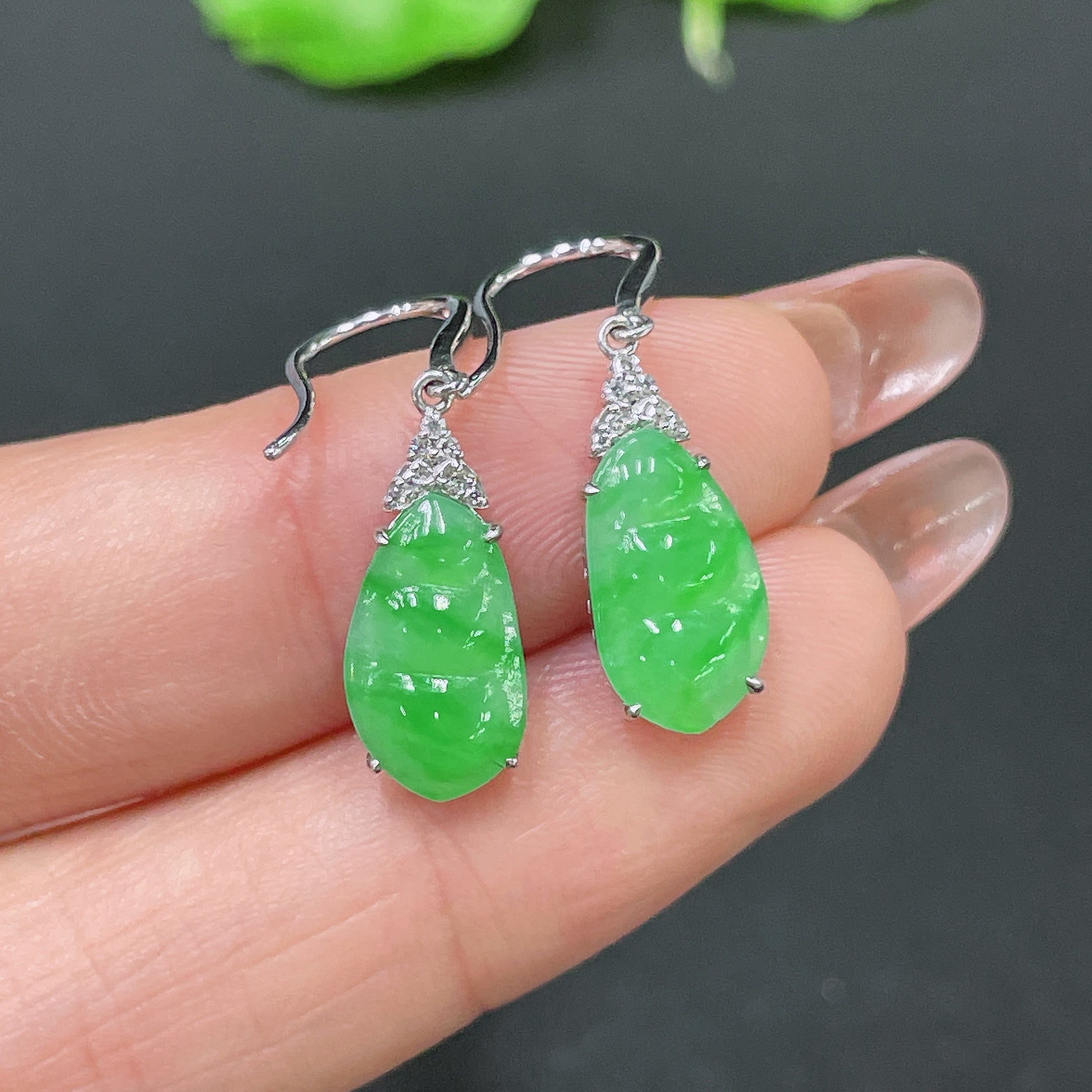 Jadeite earrings by HUILIU HQ with 18k gold inlay and diamond accents, showcasing elegant green jade stones on a white background.