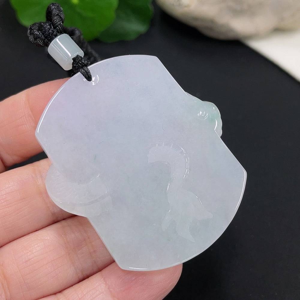 Jadeite dragon pendant from HUILIU HQ with intricate dragon design, weighing approximately 34.52g including rope.