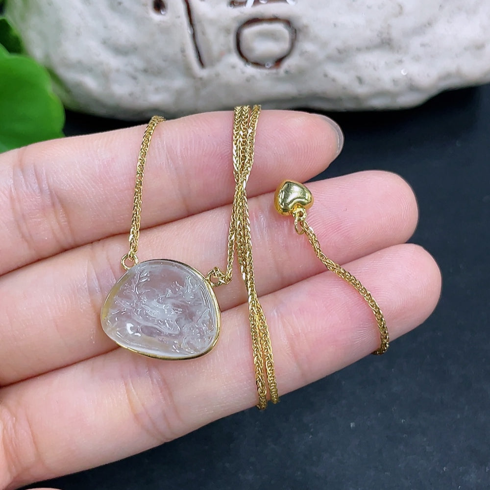 Jadeite pendant in 18K gold with chain from HKHQ, featuring a smooth, polished green jadeite stone on a delicate necklace.
