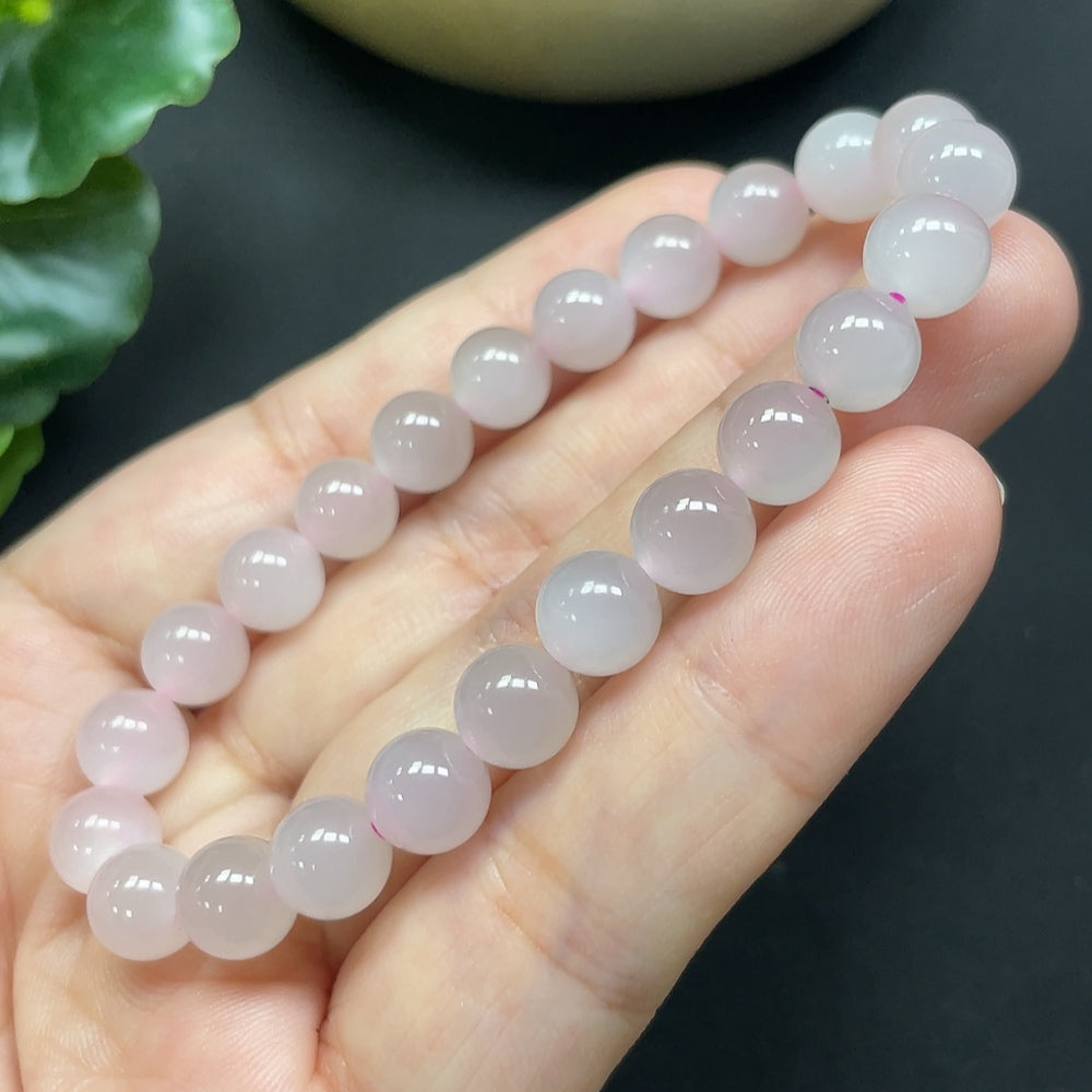 HKHQ Hetian Jade bracelet with 7.7mm smooth beads, showcasing a luxurious and elegant jewelry piece.