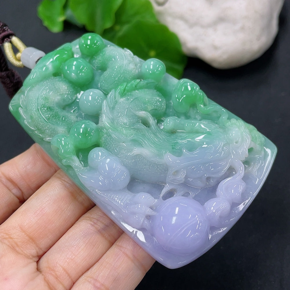 Jadeite dragon pendant from HKHQ, intricately carved in vibrant green jade, weighing approximately 103.89 grams.
