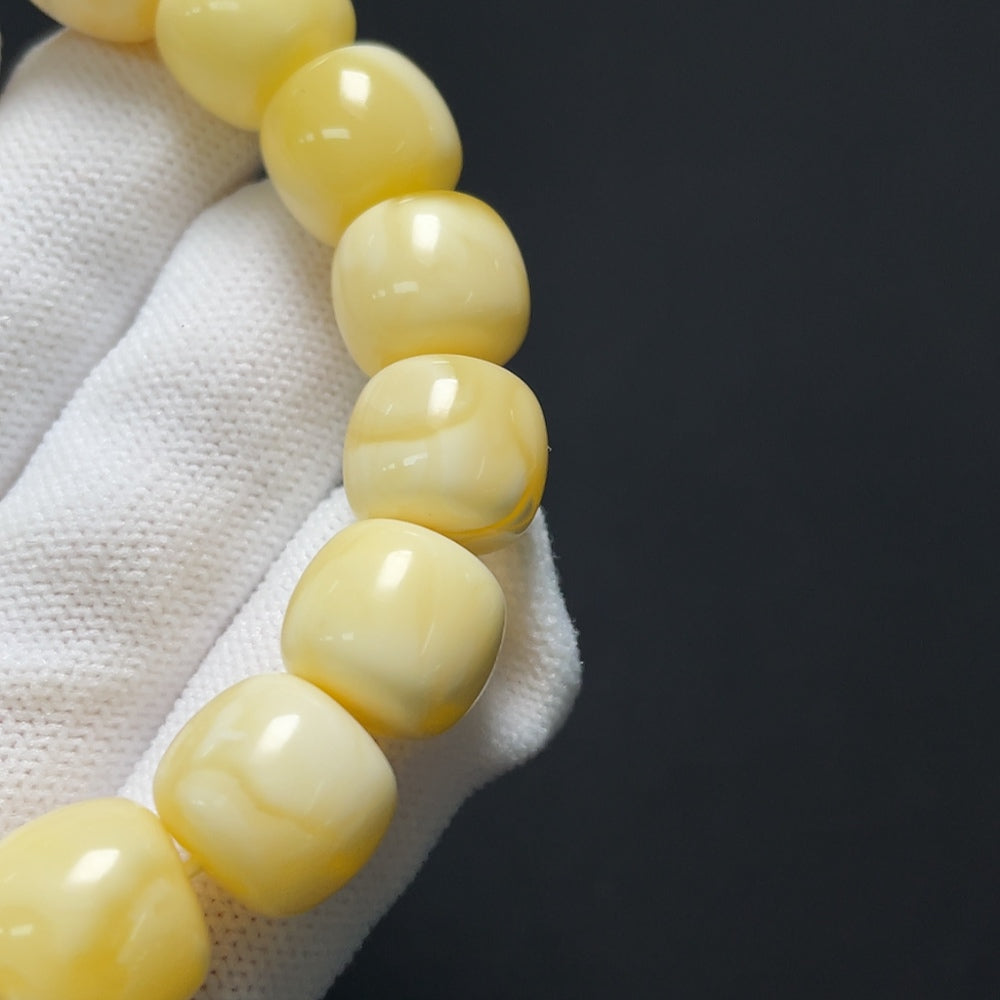 Amber Beeswax Bracelet by HKHQ featuring natural amber beads and a secure clasp, showcasing warm golden hues and craftsmanship.