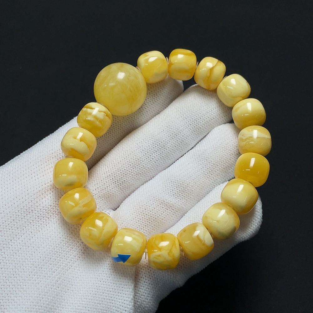Amber beeswax bracelet by HKHQ with visible repairs, weighs 19.22g, size 11.4-18.8mm, showcasing warm amber tones and craftsmanship.