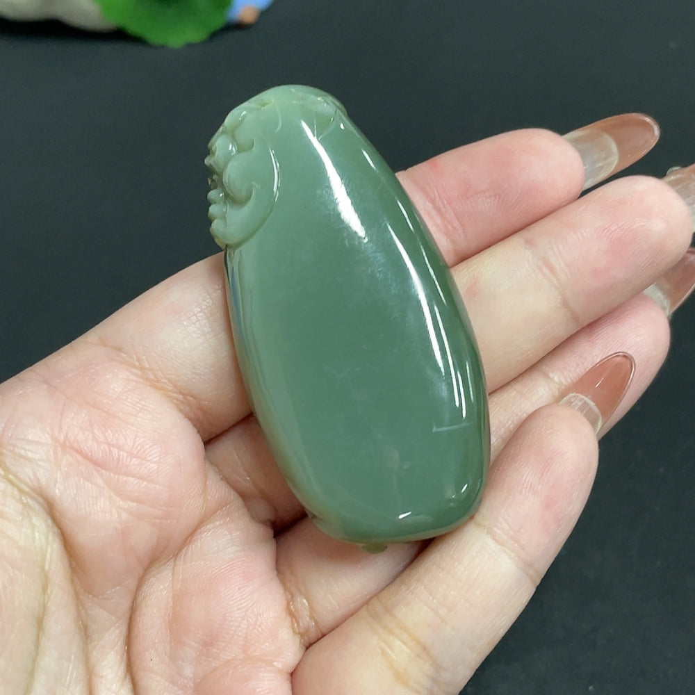 Huiliu Certified Hetian Jade Pendant featuring an auspicious beast design, crafted from smooth, polished jade in natural hues.