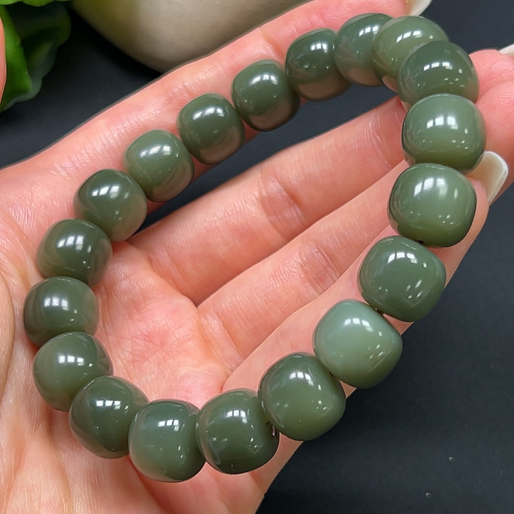 Hetian Jade bracelet with 12mm beads from HKHQ, showcasing smooth, polished green jade stones on a delicate bracelet.