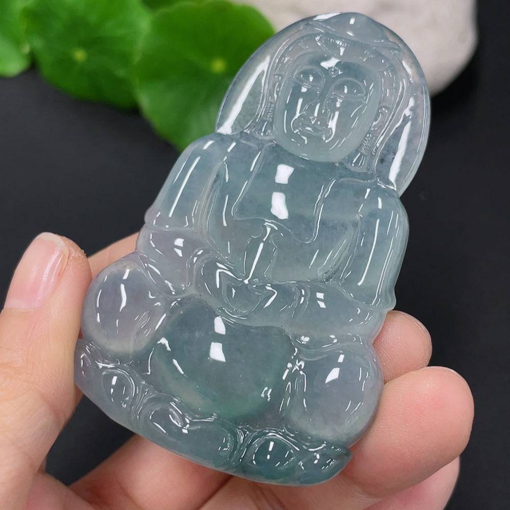 Jadeite Guanyin pendant crafted from green jade, weighing approximately 27.26g, displayed against a neutral background.