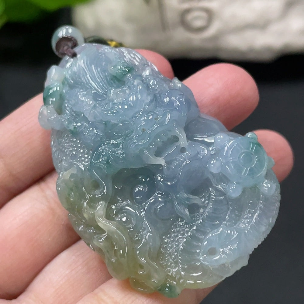 Jadeite dragon soaring pendant with intricate carvings, weighs 46.3g including rope, from HUILIU HQ Master Collection.