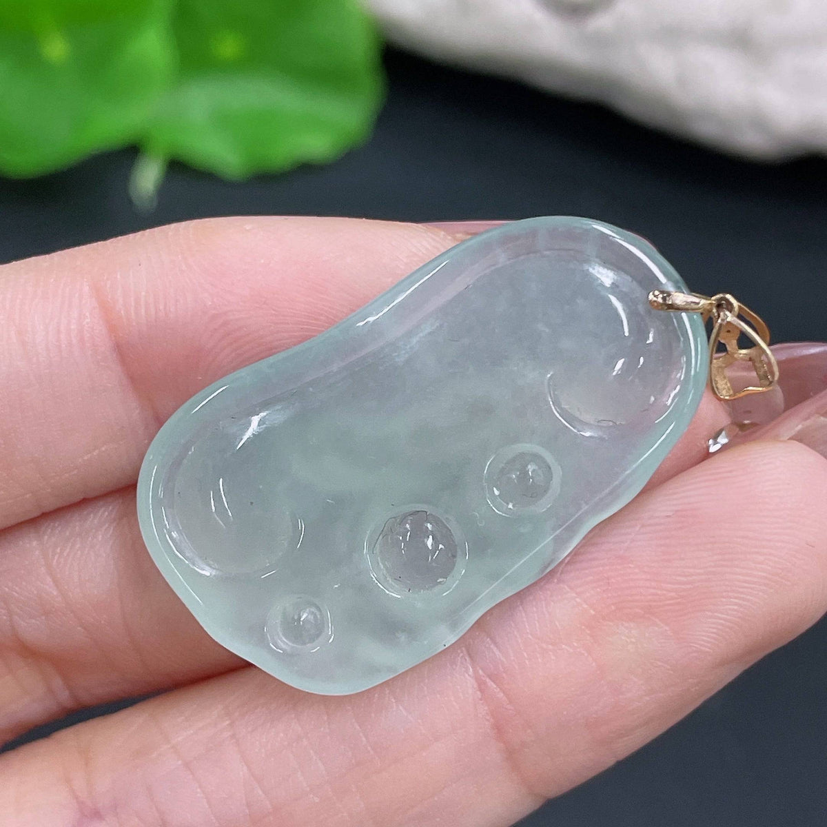 Huiliu Jadeite Buddha pendant with bezel, showcasing detailed carved jade Buddha on a smooth green jade surface.